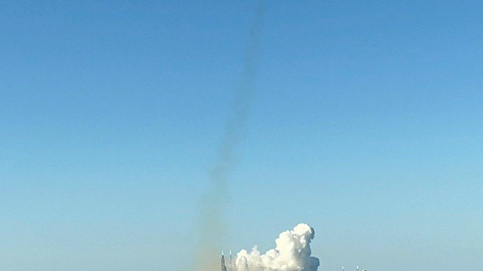 Liftoff seen from distance over the water